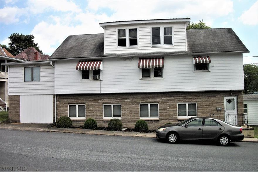 This well-kept house on a large lot can be used as a single-family residence with a mother-in-law suite or as a multi-family unit. The main level has radiant floor heat, a spacious living room with a wood fireplace insert, a kitchen with plenty of cabinet space and a large bedroom. The second level has oak cabinets in the kitchen, oak floors in the dining and living rooms, four bedrooms, a den with a cedar closet and oil hot water heat. The two-car detached garage can be accessed through the breezeway, which will keep you out of the elements. The lower level has a separate entry door for privacy.  Located in the Everett Borough at the east side of town, this property offers easy access to shopping, recreation, Interstate 70 and the PA Turnpike.