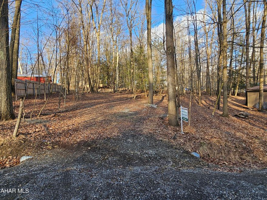 1/3 acre vacant lot in Glendale Yearound. A MOBILE HOME may be placed on this lot, but other types of homes may also be placed here. This lot has been reclaimed. Water and sewer taps are present and paid for. Glendale Yearound is a gated community located minutes from Glendale Lake and Prince Gallitzin State Park. Community pool, basketball, tennis, security, and more.