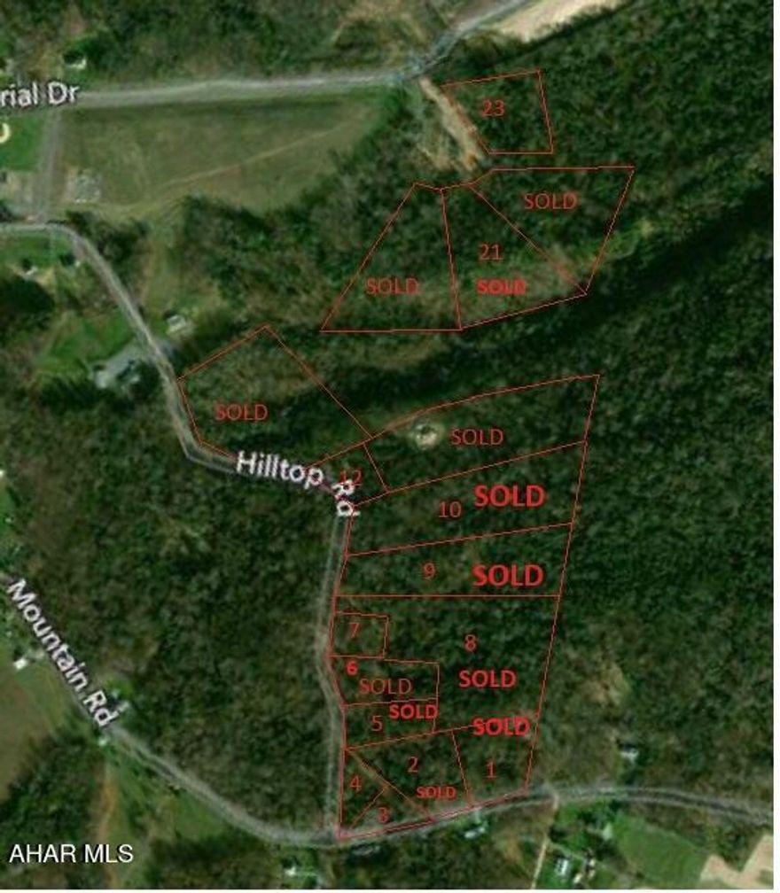 Wooded building lot, city water runs on opposite side off Hilltop Road there may be an opportunity to extend it to lot at Buyer's expense).  Otherwise buyer to drill well. Sewer lateral to lot line.  Electric along Hilltop Road.  Buyer responsible for any extensions/connections to any utility, storm water management and the obtaining of a driveway or other required permit(s). One of the owners is related to a licensed real estate agent(s).