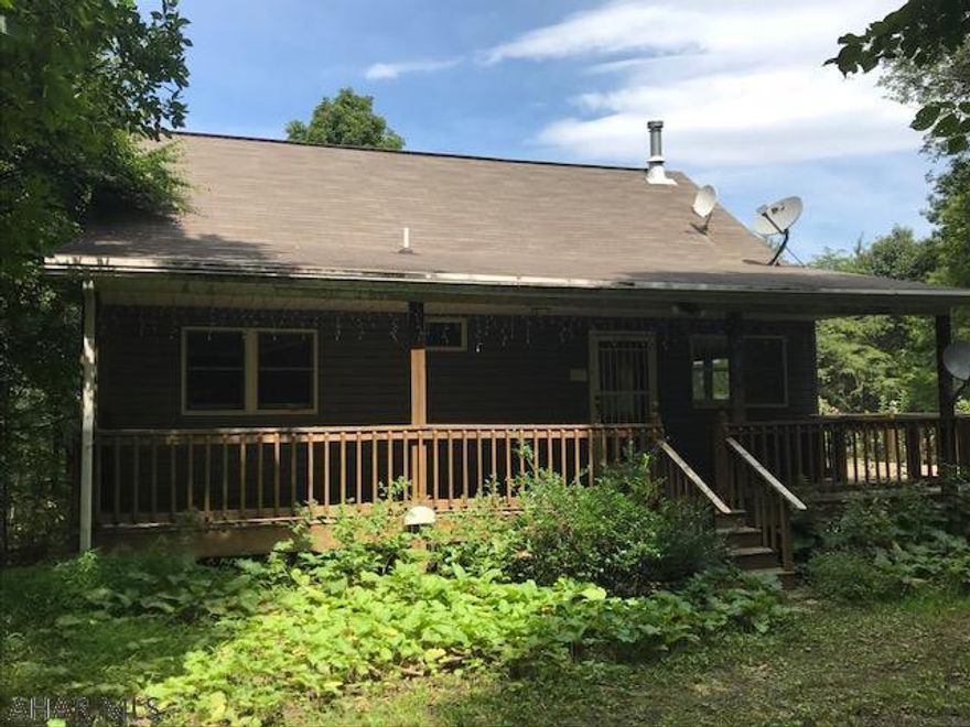 Gated community on scenic Bunn's Mountain only 5 miles to Lake Raystown.  Close to State Gamelands #67.  As a weekend getaway or year round residence this sweet home is super private.  Bunn's Mountain Property Owners Association cares for road & is only $150/year.  Deed restrictions are being updated.  Woodburner in great room and in basement supplement the oil heat.  Wraparound deck adjoins house and above ground pool.  As is Where is sale.