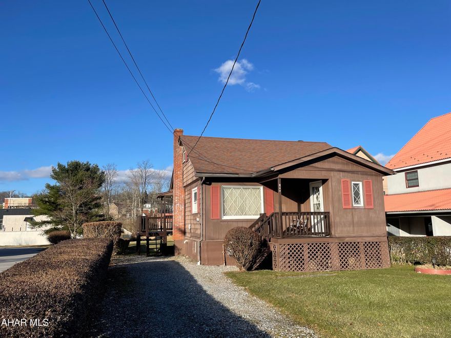 This property's unique location makes it's uses versatile as it could serve as a rental property or someone starting out or even if you were looking to downsize.  The mudroom is perfect for coats and shoes.  The living room can accommodate several pieces of furniture, the dining room is the perfect place for breakfast in the morning or dinner in the evening.  Kitchen feels spacious as it is open to the dining room.  There are two bedrooms on this floor and a full bath.  The walk up attic was used as two bedrooms one being captive, ceiling height is lower great storage for totes or seasonal items.