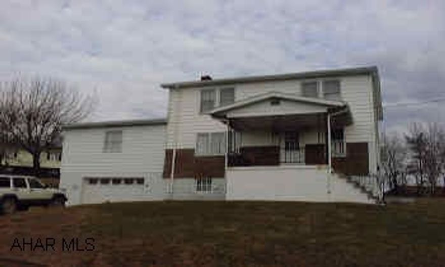 Oil & coal furnace, covered front & back porches, 1 1/2 car integ. garage, large lot, vinyl & perma stone siding.