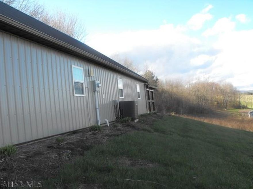 Looking for the sweet life? This acreage is a perfect mix of open fields and woodlands. Perfect for you to "spread out" a little in the country. Less than ten minutes to Shawnee Lake for fishing, swimming and camping! There is an adjoining parcel the seller owns of ten acres that would also be available for additional purchase, mainly wooded. Sellers built the attractive residence to live comfortably in: Beautiful hickory cabinets in the kitchen with punched tin backsplash and loads of storage space, Central Air and Ceiling Fans. New patio (covered) makes a nice place to sit out and watch the wildlife or have a cook-out! The garage is in pristine shape and can hold 3 cars. Call now to see! PRICE REDUCED to reflect need to tap into Public Sewer