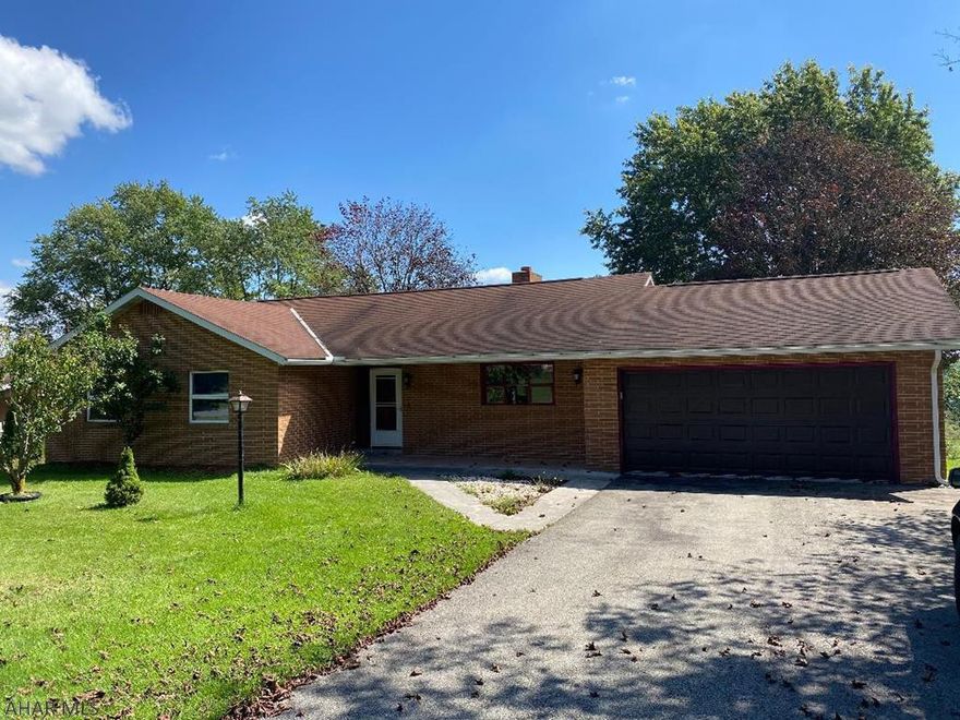 Brick rancher with eat-in kitchen, 3 bedrooms, 1.5 bath and one car garage. Nice level lot w/ paved driveway. Living room w/ wood burning fireplace and large windows to take in the scenery. Large foyer. Basement features family room w/ paneling and carpet. Basement kitchen for canning or cooking holiday dinners w/ laundry facilities. Large utility room w/ tons of storage. Additional room in basement could be 4th bedroom. Very sturdy and well-built home.