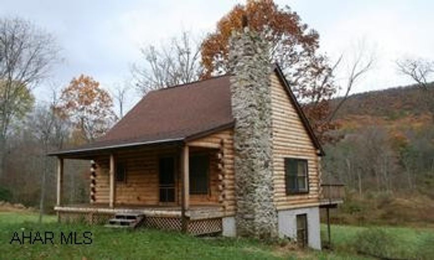 Rustic Pine Log House on 20 acres with stream. Rustic pine log house on 20 acres with stream. Adjoins State Gamelands. 2BR/1 full bath, one BR on main floor and 2nd is a loft bedroom. Cozy living room with wood-burning stove. Eat-in kitchen. Covered front porch, rear deck overlooks the mountains and stream. Walk-out unfinished basement has 6 windows and wood-burning stove, could easily be finished for additional living space. Ideal vacation home. Great hunting!