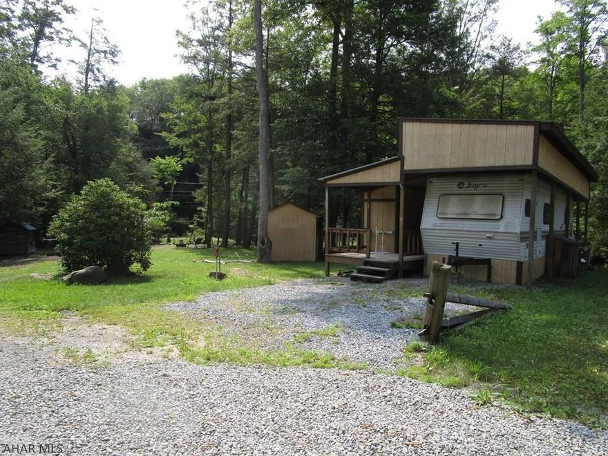 Imagine sitting next to a campfire with the sound of a babbling creek beside you. That's what you will enjoy while camping at this double campsite in Glendale Yearound. Lots of room for parking your car, boat and other toys. Camper and addition offer sleeping for the whole family with privacy most camps don't afford. Bath and a half makes everyone happy. Plenty of storage space and a full kitchen in the shed next to the campfire area for convenience. The water is installed below the frostline so you can use this property even when it gets cold. Glendale Yearound property owners have use of the heated pool, tennis/basketball/volleyball courts, dog park, club house, playgrounds, pavilions and more.