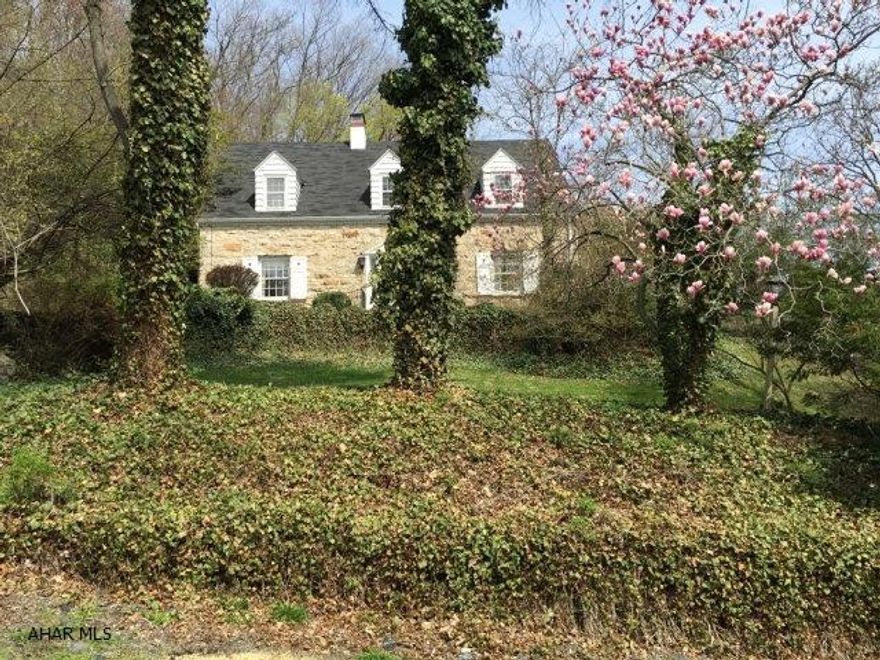 A million dollar view within an 8 mile drive of Omni Bedford Springs Resort, tucked up under a ridge, sits one of Bedford County's prettiest homes. This 2132 square foot, 3 bedroom, 3 bath English style home was constructed of the highest quality. Stone exterior, gorgeous terraces and lush landscaping add to the absolute charm and character. The interior boasts beautiful hardwood floors and wonderful architectural details. A central foyer opens onto a large formal living room with French door. Terraces are found off the kitchen and living rooms and are surrounded by stone and lush landscaping that mimic an English garden. Simply stunning home!
