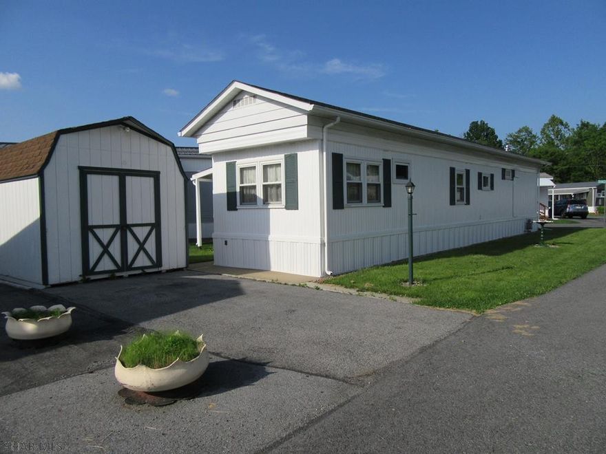 Age 55+ Community. Ready to move into. Freshly painted. New Thermo Tilt In Windows Throughout. New Central Air. Newer Roof. Well Serviced Furnace...New Thermo Cuppler. Bath has just been updated...Wonderful New Walk in Shower. New Flooring in Kitchen. New Carpet in Bedroom. Large Shed. Huge Carport with Patio Area and Covered Back Porch. Also has a Separate Driveway for Parking as well. Lot Rent is $353 includes water, sewer, trash and snow removal.