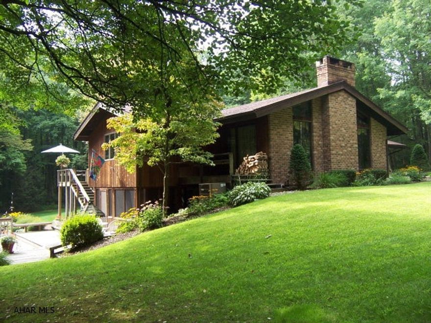 A super and sprawling ranch, that you will fall in love with at first sight.  The perfect, private setting, just lures you in and fills you with excitement at first glance.  The open concept and flow of this house, the large windows and light, vaulted ceilings, hardwood crafted floors, brick cased range area, gun room, man cave, lower screened porch and open sun room, are just fantastic!