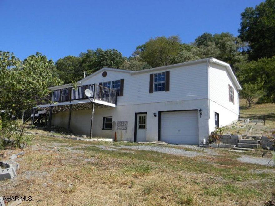 Large doublewide with 3BR/2BA on 3/4 acre lot with a nice view. Featuring a cheerful sun room, big living room and eat-in kitchen, front and rear decks and full unfinished basement and garage. Offered As-Is. Immediatley available!