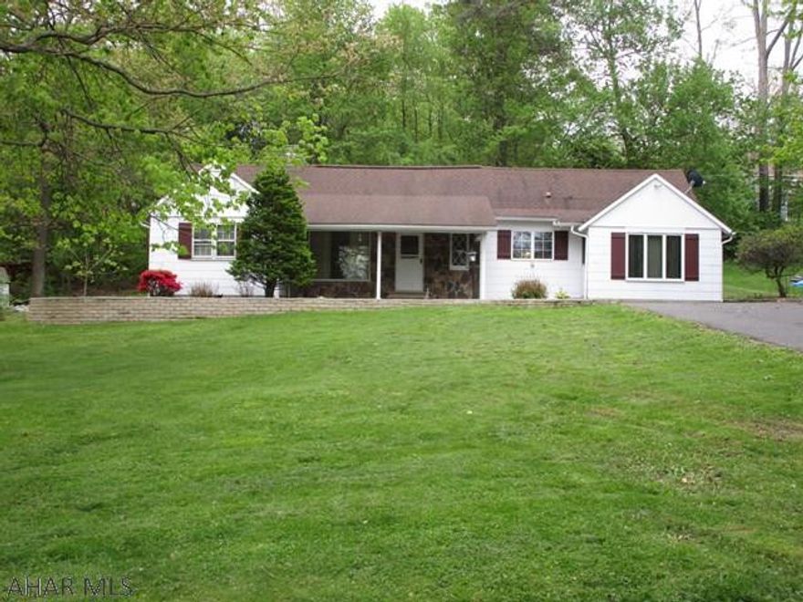 Spacious one and one half story home with a large yard!  Offering a living room with stone hearth fireplace and cathedral ceiling, galley kitchen, large family room and dining area, main floor laundry room, full bath, master bedroom with half bath and another main level bedroom.  Second story offers a large bedroom with a half bathroom.  Large front covered porch perfect for relaxing, tree shaded lot, blacktop driveway and one-car garage.