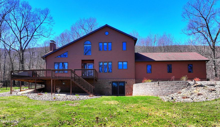 Welcome home to this 3 bedroom 2.5 bath home located just south of historic Bedford, situated on a peaceful, wooded country setting. Offering a comfortable layout designed for both everyday living and entertaining, featuring a gas fireplace in the main living area, a first floor home office, and main floor laundry for added convenience.  Natural light fills the home, and the expansive deck is the perfect place to enjoy your sunrise views over morning coffee.
The lower level offers additional living space with a second gas fireplace, perfect for a family game room, movie nights, or a casual hangout space.  An attached 2+ car garage with workspace provides plenty of room for storage, projects, or hobbies.  An additional greenhouse plus multiple sheds add even more opportunity for gardening and outdoor enjoyment.  Set on 1.98 acres, this home provides the privacy and room so many buyers are looking for, all while being just minutes from downtown.  Give us a call today to make this wonderful property your new home.