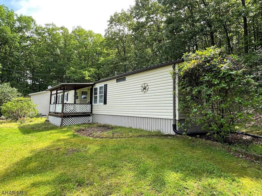 Very well maintained single-wide home resting on 2.64 acres!! This home offers a living room, kitchen, laundry room, master bedroom w/ master bath, one additional bedroom, full bath, office area and mud room. Two-car attached garage and one-car detached garage with electric. Covered front porch, private well and private septic system. Vinyl sided, thermo pane replacement windows, oil forced air heat and central air-conditioning. Beautiful country setting with beautiful views. Home is move in ready!!