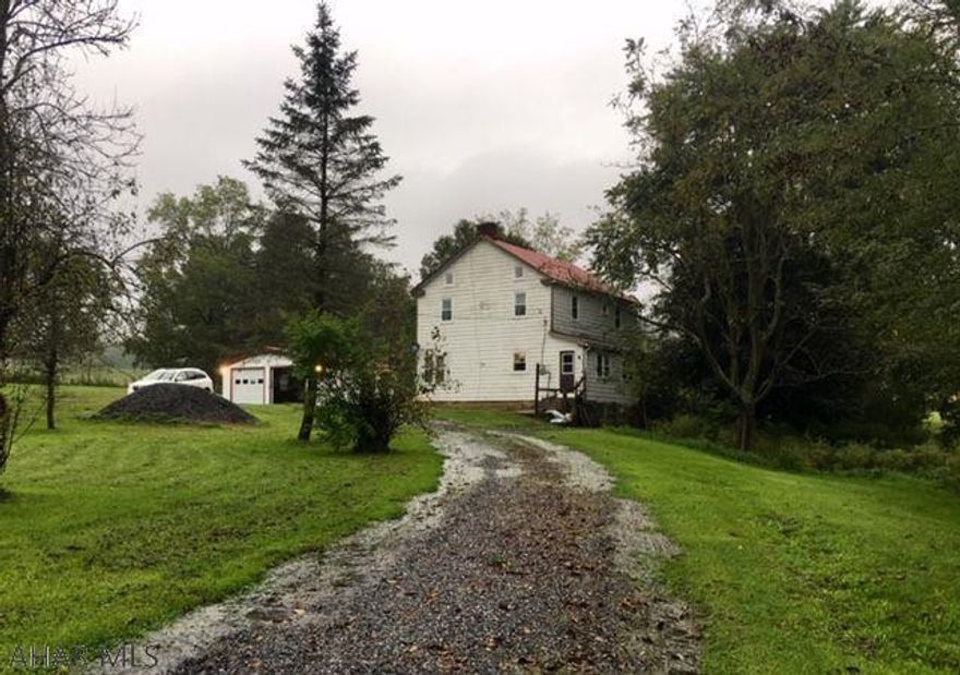 Lovely rural setting. Large home, new 2 car garage. Newer roof, updated electric, windows and furnace. Home needs TLC. 2+ acres with circular drive.