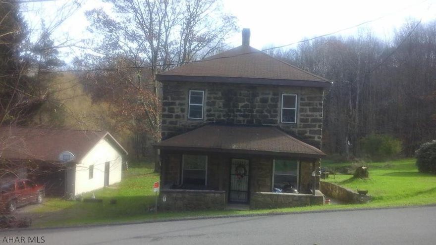 If you like the Uniqueness of Older Homes, don't miss this all stone 3 bedroom, 1 bath home on .9 acres with 3 bay garage (could be heated) with plenty of parking and storage.  Deck off kitchen for those summer evenings of outside enjoyment.  Sold "AS IS".  Seller's Disclosure states septic test failed, Seller had septic re tested by Don Cessna and system passed.  Seller's Disclosure is being updated with documentation of passing septic test.