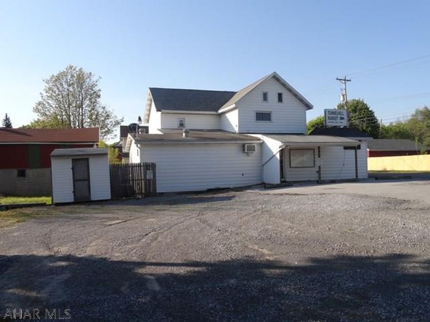 Live where you work.  This 4 bedroom, 2 bath home has a storefront, office, storage rooms, and plenty of space to open your own place of business.  Formerly the Tunnelhill Market.  Also included is a 2 car detached garage with loft for storage and 4 tracts of land that total over an acre.  Lots of parking too!