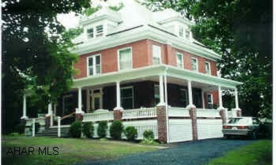 Elegant 2.5 story four square brick home located in exclusive section of Bedford Borough with elaborate wraparound porch on large corner lot.  Embellished with leaded glass entry, vestibule and dining room built-ins, Library, hardwood floors throughout and original oak trim and decor.
