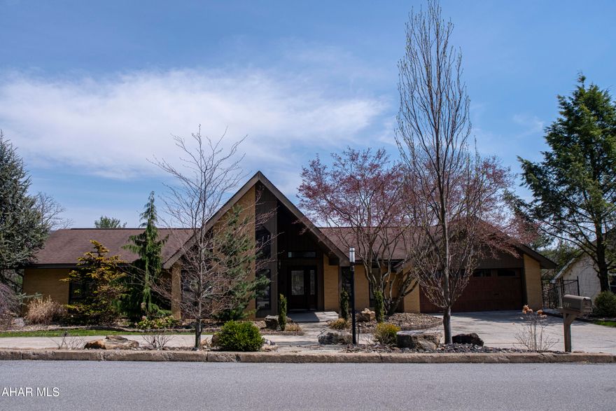 Welcome to 313 Ridge Avenue - a beautifully maintained home offering the ease of single-floor living with the space and versatility to grow. This 3-bedroom, 2.5-bath property sits in a central, convenient location just minutes from Highland Park, shopping, schools, and more. Whether you're looking to downsize upkeep or need room to expand, this home delivers comfort, functionality, and style.

Step inside to find Brazilian Tigerwood hardwood floors flowing throughout the open main level, bathed in natural light from large Pella windows with integrated blinds—a subtle luxury you'll come to love. The spacious living room features a ventless gas fireplace with a heat blower, adding cozy charm and efficient warmth year-round. Both full bathrooms offer a touch of spa-like comfort with heated tile floors, making mornings and evenings feel just a bit more luxurious. The heated two-car garage with additional storage ensures all your vehicles and gear stay protected and organized.

Designed with both pets and people in mind, this home includes dog doors and a dedicated dog run, perfect for four-legged family members. Professionally landscaped curb appeal greets you out front, while the brand-new rear deck steals the show—a standout feature built for enjoying fresh air and sweeping Central PA views. With easy access from the kitchen, living room, and lower yard, the deck is ideal for entertaining or relaxing at any hour. (And yes, it's solid—bring your grill, your guests, and your favorite lounge chairs.)

Downstairs, the unfinished walk-out basement is a blank canvas—ready to become your new rec room, home gym, or guest suite. Whether you're moving in as a couple, a growing family, or downsizing without compromise, this home blends low-maintenance living with spacious potential.

Don't miss your chance to own a home that offers so much more than meets the eye—style, comfort, convenience, and room to grow, all in one perfect package.

Additional Features: 
  Primary suite includes; private bath, vanity table, dual closets, and skylight

  Vaulted Ceilings in living space

  Mudroom and laundry room

  Eat in kitchen & formal dining room

  Basement unfinished sf = 1,405