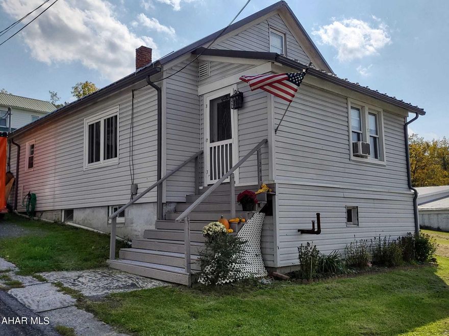 Lovely 3 bedroom, 2 full bath cape cod on quiet road in Manns Choice. Nice back and side yard for playing or entertaining. Large attached carport with attached deck. Close to Shawnee State Park and Lake, State Game Lands, and short drive to Downtown Bedford and local amenities.  Many outside updates include: new roof and gutters, siding, and windows. From the carport you can enter into the eat in kitchen. Dining/Living room combo have original hardwood floor and new paint. Bonus room off the living room has brand new carpet and paint along with recessed lighting; or could be converted to a fourth bedroom if needed. Two bedrooms and a completely remodeled full bath complete the main level. Laundry hook ups in the second bedroom if main level laundry is ideal. Second floor has large landing for many uses such as an office area, child's play area, storage or closet. Large carpeted bedroom and a full bath with standing shower. Unfinished basement has concrete floor, laundry hook ups, brand new water softener (owned), and 200 amp service.