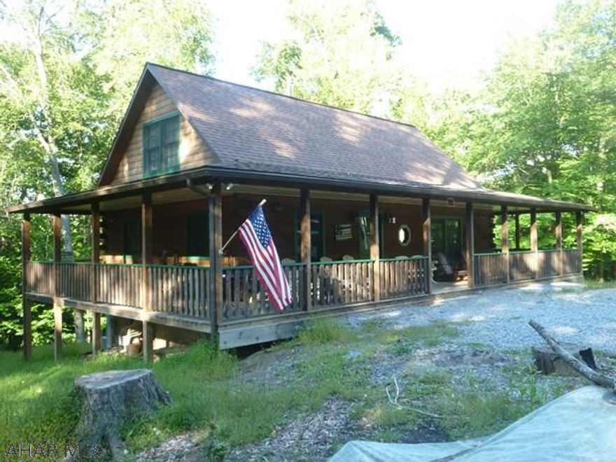 Yes, you can have it all!  Gorgeous real log cabin with wide wrap around porch.  Four bedrooms, two on the first floor, two full baths, roomy loving room and a kitchen with space for all your cooking needs.  The wood stove in the living room can keep the entire home warm, if needed.  Too many extra touches to enumerate.  Lighting on porch allows you to enjoy nature into the night.  The full basement with double walk out doors enables you to park your quads or mowers with ease.  With four bedrooms there is room for the whole, extended family or all of your hunting friends.  This beauty is part of Glendale Yearound and its amenities but is located outside of the entrance gate, closer to Prince Gallitzin State Park / Glendale Lake and State Gamelands 108.