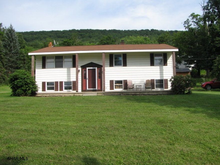 Tyrone bi-level on 1 acre! LR.,, large EIK w/island, updated full bath w/ custom vanity and cabinetry, 3 BR., lower level offers bonus room space and plumbed for 2nd bath! New heat pump for heating & cooling plus wood burner for optional heat source!