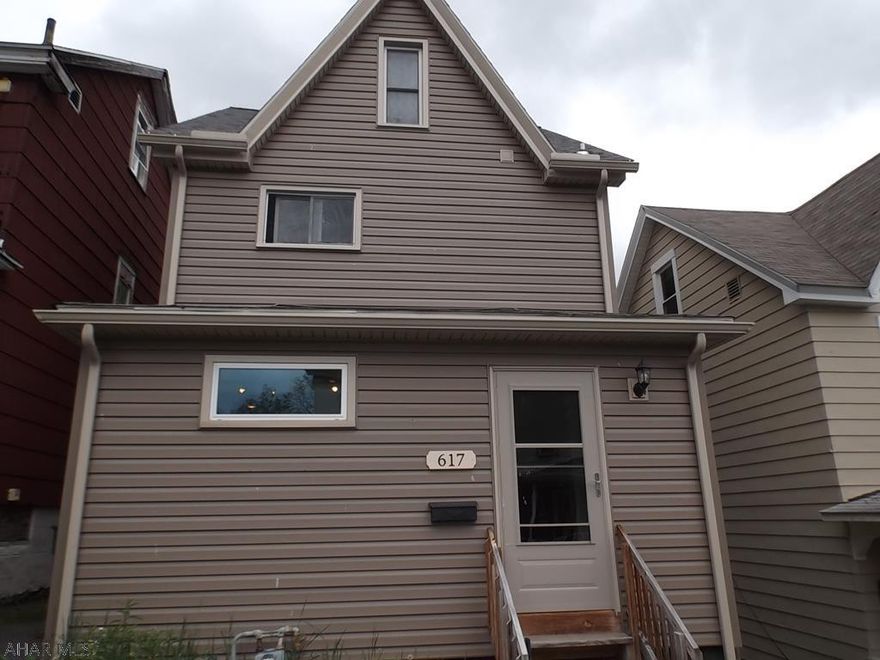 Great house for te money!!!...............Maintenance free exterior (newer siding,roof, windows, soffit  & fascia.   Once inside, you will appreciate the new flooring and  obvious OPEN floor concept.  Updated kitchen as well.  Upstairs are 3 Bedrooms (one is currently the "convenient" laundry room) but you could move laundry back to basement if you wanted. Plus there is a finished attic.  Although the home is currently zoned electric heat;  the current owner is leaving a hot air furnace for new owner to install is they choose to do so.  The rear yard is already fenced in for the kids and/or fur babies:) and......................there is NO neighbors behind, just a lovely patch of woods to enjoy!!