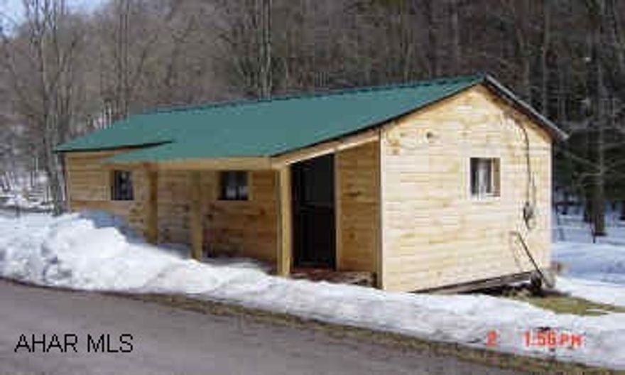 You'll Love it here!!!!!!!!!!!  wooded acreage with a stocked trout stream passing through the property, cabin with electric, water fall, borders State Game Lands I99 S to 30W to 31 W, go approx. 16 miles, turn left on SR 2019 (8 miles to Fairhope), go approx. 7 miles turn right on Sheaffers Run Road, cabin will be on your right