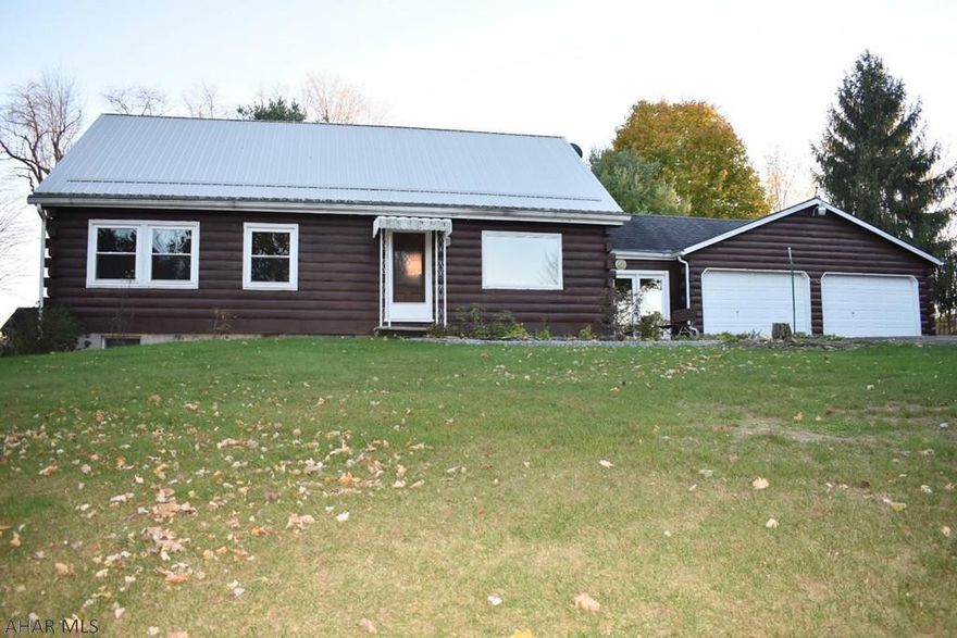 Location, location!!!  This 3 bedroom 2 bath log home is situated on a private 3.32 acre lot in the Spring Cove School District.  This home offers an open floor plan with cathedral ceiling, main floor living, a beautiful sunroom, paved driveway and an oversized 2 car garage.  There is a loft that was most recently utilized as a 3rd bedroom.