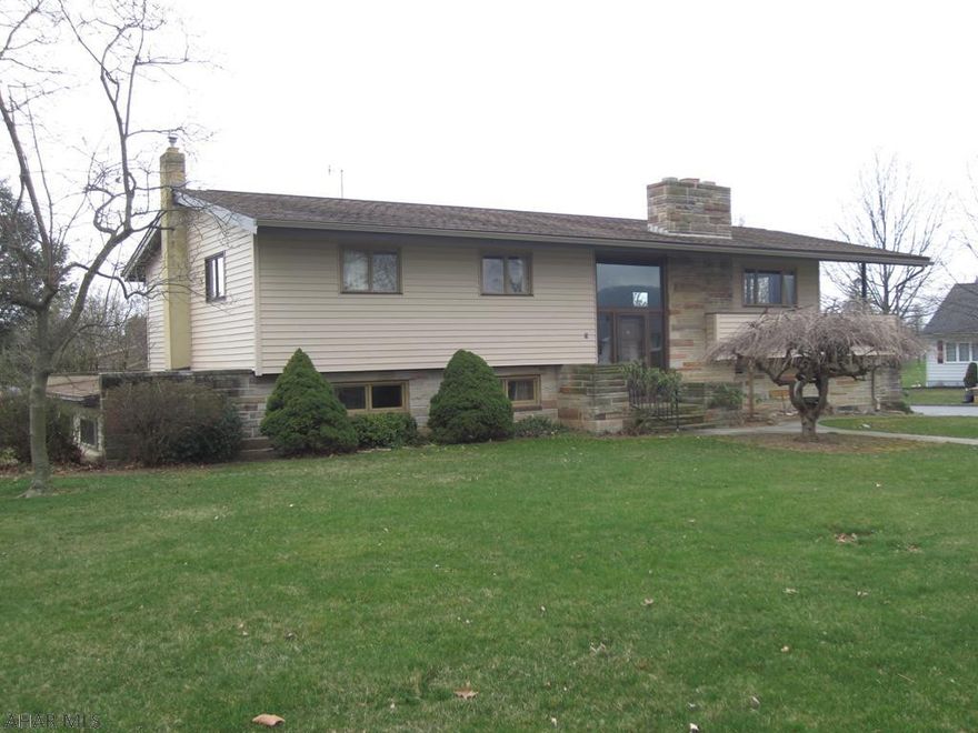 It's the location that makes this property very appealing. With a great view of Lock Mountain, this solid, well built plastered home has much to offer.  It has a covered wrap around deck, integrated garage, stone and vinyl exterior w/nice storage building.  The main level has 3 nice size bedrooms, 1 full bath, large living room w/fireplace, dining room and kitchen. All hardwood floors thru out, w/tile in bath.  Lower level has large family room, wet bar, full bath and lots of storage with many more amenities, this uniquely crafted home is one that you'll want to see.