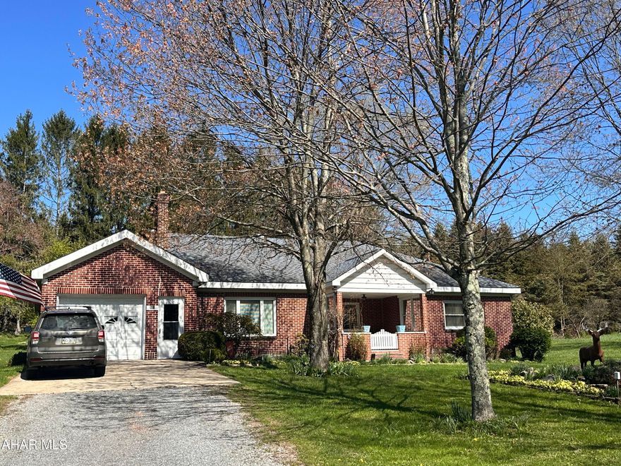 Beautiful brick ranch home on 1.4 acres.  The spacious eat in kitchen is perfect for entertaining! Enjoy your morning coffee on the rear enclosed porch with nature views. There are three spacious bedrooms and 1.5 baths, and den that could be used as a 4th bedroom.  The living room features beautiful built in bookcases and a fireplace.  Two heating sources give you an option to heat with oil or wood/coal. The walk up attic could be finished into additional living space.