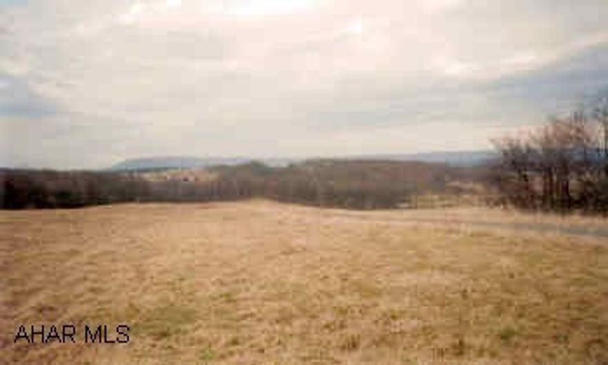7.02 Acre lot in Shawnee Settlement with mountain view, underground utilities (telephone and electric) and just minutes from Bedford. Horses permitted. Well to be drilled by buyer, sand mound to be installed by buyer.