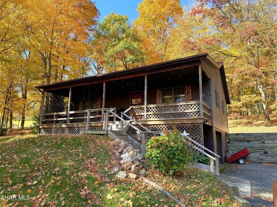 This ranch home rests on a beautiful .90 acre lot with picturesque trees. Large front covered porch perfect for relaxing and enjoying the views. Main level offers a living room, kitchen with breakfast bar, dining room, two bedrooms and a full bath. Basement has another full bathroom, storage room with built-ins, laundry area, and a one integral garage. This home was built by Bill Waltman. Updated shingle roof, heat pump with central air conditioning, oil hot water furnace and 200-amp electric. Hickory hardwood floors, ceramic tile kitchen and bath floors, oak kitchen cabinets and double pane windows. Paved driveway, storage shed, and a large front yard. Convenient location to Bedford, major roads, and Maryland.