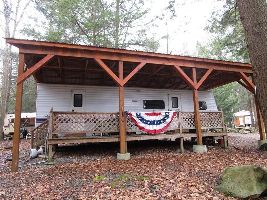 You won't find many campers with two bedrooms And 2 bathrooms! Camper and deck are protected by a pavilion with a metal roof. Seller uses a portable electric heater for heat, when needed. Located in Glendale Yearound, a gated recreational community adjacent to Prince Gallitzin State Park / Glendale Lake and six miles from Rock Run ATV Park.  Seller has adjacent property for sale also.