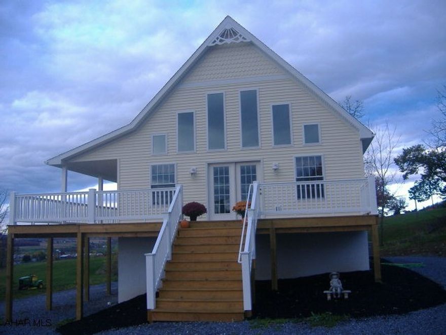 WOW WHAT A VIEW STAND ON THE  WRAP AROUND PORCH OR LOOK OUT THE LIVING ROOM WINDOWS ITS JUST BREATH TAKING...THIS HOME WAS CONSTRUCTED IN 2009/2010 AND SITS ON 1.17 ACRES..THIS HOME FEATURES 1ST FLOOR OPEN FLOOR PLAN ,HARDWOOD FLRS,2 BEDROOMS, 1 FULL BATH, KITCHEN W/ OAK CUPBOARDS AND ALL APPLIANCES, 2ND FLR LOFT IS MASTER BEDROOM WITH LARGE PORCELAIN TILE SHOWER, BASEMENT LEVEL INCLUDES A BATH, FAMILY ROOM, LAUNDRY AND A BEDROOM , A HEAT PUMP ,R-38 INSULATION IN THE CEILINGS AND R-19 IN THE WALLS...