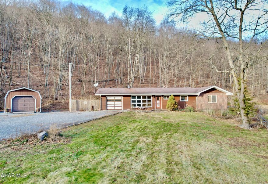 Nestled in between the mountains is this home of peace and serenity.  21 +/- acres, a stocked pond and a stream make this property complete.   The open floor plan makes entertaining easy.  3 bedrooms with a bonus room that could be an office, gaming room, reading nook, or more.  Wild life of all kinds can be seen from the property.  So much potential and so many options.  Could be primary residence, second home, hunting cabin, farmette, or more.