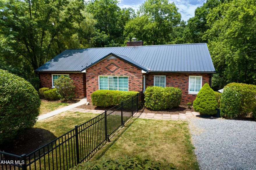 A very nice, well-maintained brick and vinyl siding ranch style house offers a haven of comfort and serenity.  Situated on .71 acres, the house features 3 bedrooms and 2.5 baths with a walkout basement and welcomes all who enters.  The floor plan is open and airy with a large porch overlooking the picturesque backyard.  Fencing is tastefully installed throughout the property, offering privacy and practicality.  The kitchen is spacious with an eat-in area and a half bath located off to the side along with an open storage nook.  The living room and dining area offer a perfect gathering space for family and friends.  The bedrooms and a full bath are located off the living room along the hallway.  The 3rd bedroom is also an ideal office space.  The attic is converted into a hobby area and additional lounging as desired.  Walk downstairs into the basement and there is storage galore, a large laundry area, a full bath, and additional space for creative options.  Walk outside to the patio that is home to two small hobby ponds amongst attractive landscape and kept secluded within split rail fencing with wire screening.  Finally, step into the park-like backyard, also fenced, offering the best in outside living.  Whether you are a first time buyer, downsizing, or making a change, tour this impressive property, conveniently located, and ready for you to call home.