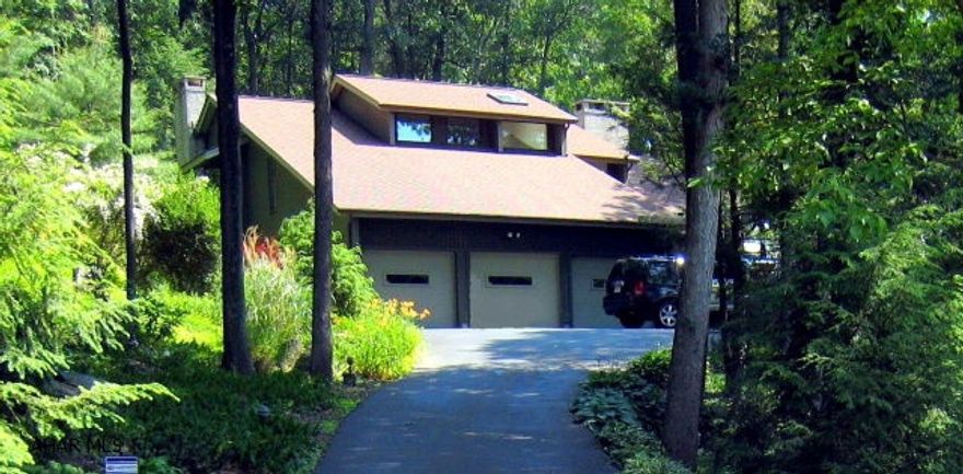 Updated home on mature wooded lot .  Lot is secluded and private.Completely refurbished kitchen with new stainless appliances & granite countertops. New baths with glass shower doors & stainless surrounds. Large bedrooms with plenty of storage. Magnificent views from all windows. Three car garage.