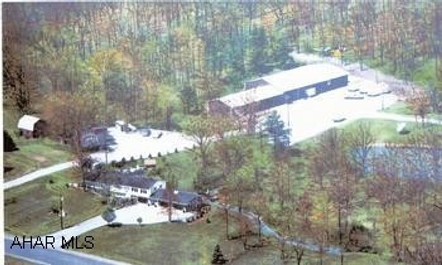 Residential / Business Property on 17+  acres w/668' road frontage, upscale, spacious multi-level 3BR/3BA multi-level home. Property has a stream, 3 ponds, commercial buildings, 2 green houses. Business/Residential property on 17-acres w/668' road frontage on US 220 w/spacious, upscale home strategically located midway between I-68 at Cumberland, MD and the PA Turnpike at Bedford, PA. Beautiful multi-level home, 2 car garage, greatroom w/stone fireplace, skylight, stone watercourse, decks overlooking pond and stream. Five commercial buildings offer offices, showroom, heated storage, vehicle storage buildings, commercial vehicle garage and two greenhouses adjoining two large ponds.