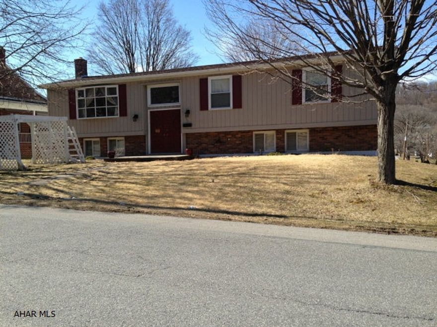 This great in-town location is wonderfully situated across from open land. The home has great private views from the living room. The kitchen/dining room has a walk out to a private deck. The home has three bathrooms and a main floor laundry room. Central air, heat pump, coal and wood furnace allows owners to decide what heating source they would want to use. Also, a three season room is found off the lower level that opens up onto a covered porch.