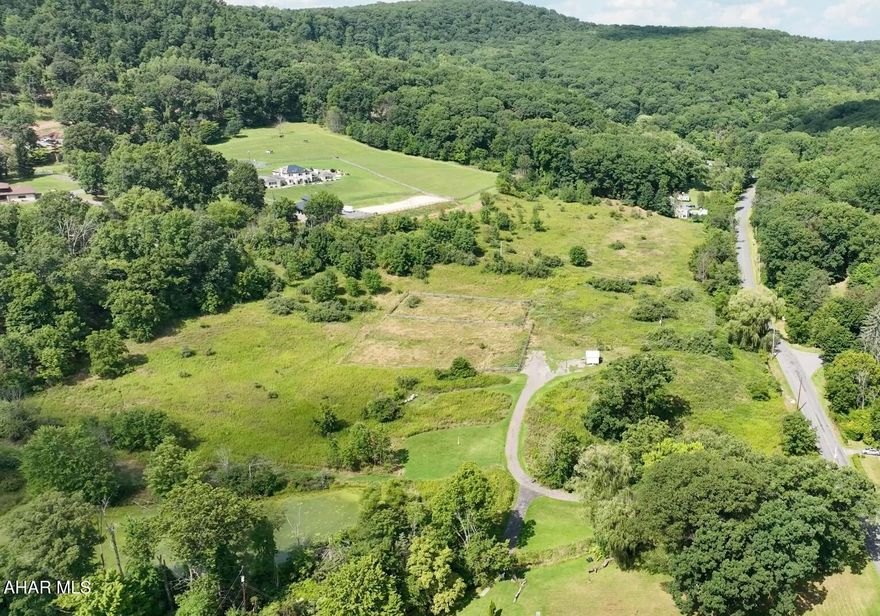 Private paved access to 15.05 acres of near level ground in Juniata Gap with 1000 road frontage feet along side Davis Rd.  Includes shed, stream, pond, year round access.