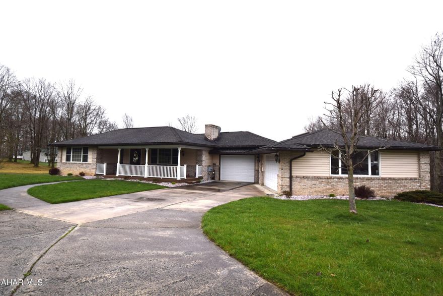 This completely remodeled one story home has been beautifully redesigned to create the open concept style so desirable for comfortable modern living.  Ceramic tile entry, hardwood floors, living room with wood burning fireplace,  well appointed modern kitchen with ceramic tile flooring.   Sunroom/Family room with new motorized custom Levelor roller shades.  Owners suite is large and has a new bath with walk in shower and heated floors.   Third bedroom has been converted to a laundry room for complete one story living but is easily converted back to use as a bedroom.   In addition to the newer oil hot water furnace, there are several split systems that heat and cool the entire house.   Beautiful covered rear and front porches to enjoy the great outdoors.