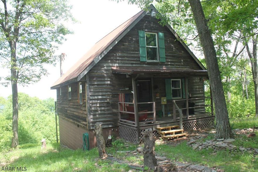 Amazing rustic adventure. Picturesque surroundings of rolling valleys and beautiful Raystown Lake. This property is situated on over an acre of beautiful ground in Huntingdon County. This home features 2 large bedrooms, an eat in kitchen and central air. On private road adjacent to federal/state game lands and in protective covenants. Updated flooring, insulation, paneling, carpeting and kitchen cabinets. Property is rounded out with a large garage capable of storing any and all recreational equipment.