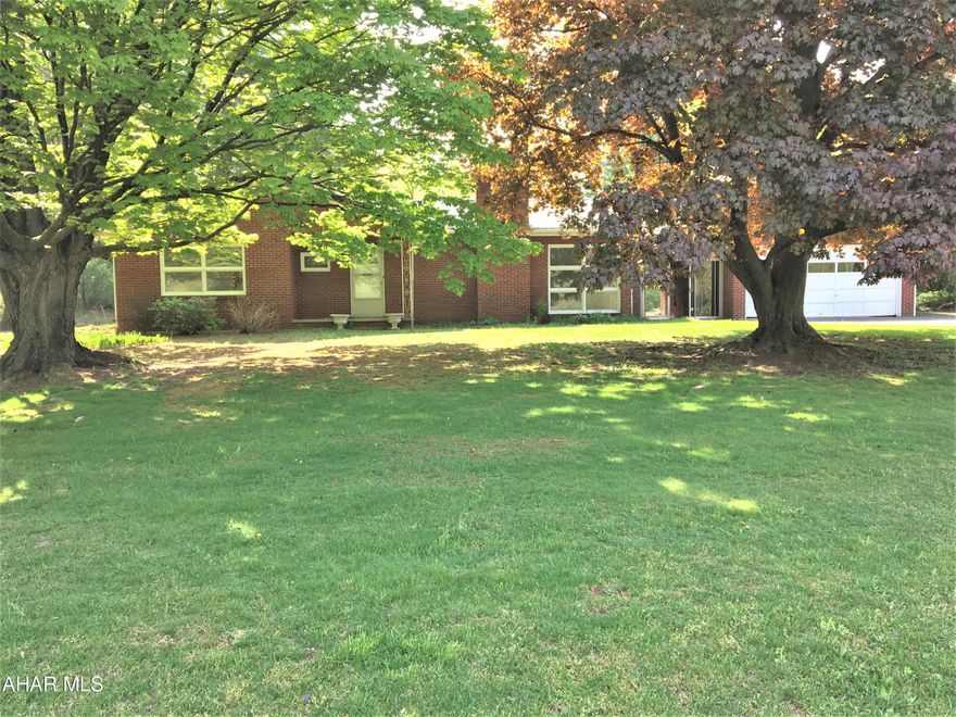 What a well built brick ranch home, with very solid bones. Has a lovely view , home sits on a cleared 1 acre part of the ground the remaining 7.15 acres are wooded and a wildlife paradise. Hardwood floors that need some refinishing to be beautiful again. Fireplace in the living room. 3 bedrooms and 1 and 1/2 baths. Full basement with lots of potential. Breezeway leads to 2 car attached garage. New metal roof, Oil H/W baseboard heat. Call to take a look !