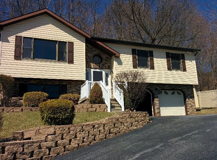 Enjoy the benefits of a like new home. Great view. Master bath w/Jacuzzi tub, master BR with adjoining hot tub on large rear deck. Wood burner in family room supplements heating system. Convenient location a couple of blocks off Pleasant Valley Blvd.