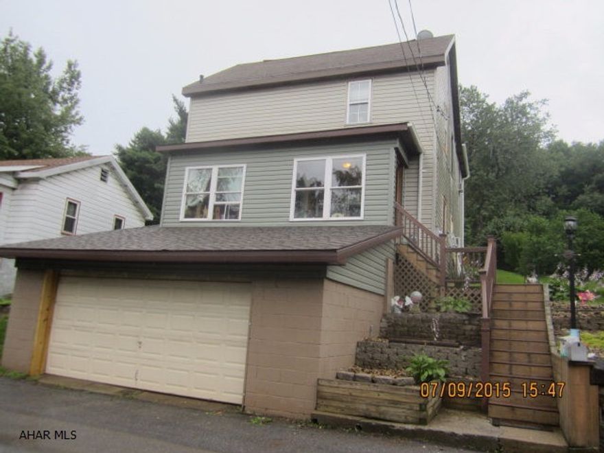 Don't miss this updated 3 bedroom 1.5 bath home with many added features!  Two heat sources-oil and wood/coal. 2 car garage and  lots of parking!!! The lot across the street provides plenty of additional parking. Relax after a long day in the Sauna! Check out the photos.