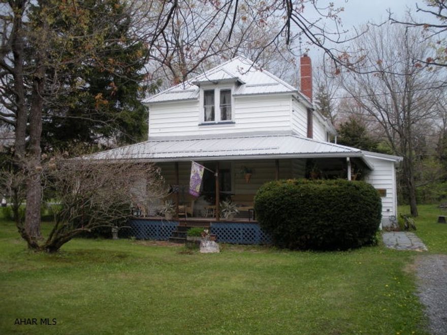 Classic charm home on Lookout Avenue, 2 bedroom 1.5 bath on a large 125X150 lot.  This home has loads of potential with the open living, dining, kitchen area with 2 fireplaces.  Some original wood floors, large windows in the kitchen area overlooking the landscaped yard & pond.  There is a large wrap around porch.  Newer metal roof in 2012, water heater in 2013.  Furnace, oil tank and Flue Liner all new in 2006.