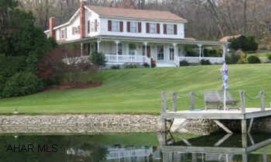 Casual yet fabulous, traditional style on 18+ acres with view, pond, barn and outbuildings. Home has 4 bay windows, crown moldings, wainscoting, and many other extras.