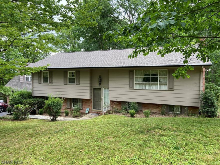 BIG PRICE REDUCTION!  Home Warranty included.  Spacious bi-level in the prestigious Beverly Hills subdivision of Altoona features 4 bedrooms and 2.5 baths.  If you are looking for your "forever" house you might have just found it.  This extraordinary house has a large master bedroom with a separate sitting/dressing room in the suite.   And from the kitchen you can enter your own private outdoor space with a covered screened-in deck (18.9 by 15.1) that leads to a large multi-tiered deck that is perfect for entertaining.  Downstairs is a family room with a wood burning fireplace and an additional rec room attached.   Plenty of storage space tucked away in this house.  It has a huge 2-car garage with space for a workshop.   And it is just minutes from PSU Altoona campus and Altoona Hospital.