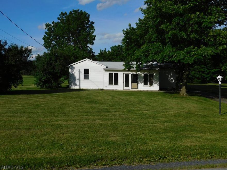 This house is an absolute must see and NOT IN A FLOOD ZONE! Whether you're looking for your first home, down sizing to one level, or even a vacation home you're going to want to check this out. There's no shortage of space with what could possibly be three bedrooms with the addition of a door. This spacious lot has a large level yard, perfect for sports activities or family gatherings, with a 2 car garage, blacktop driveway, above ground pool with large attached pool house/ year round entertainment room. Two miles from Chestnut Ridge Schools. Quiet, country setting located next to Grand View Golf Course and driving range. Centrally located between Shawnee State Park and Blue Knob State Park, there are plenty of things to do near by. Call for an appointment to see for yourself.