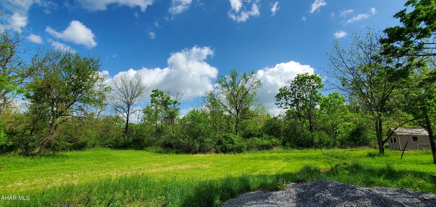 HOLLIDAYSBURG PRIVATE 11+/- ACREAGE with an additional 7363 square foot brick office building and parking lot!!  Sculp your American Dream Home on the wooded hillside at the end of this quiet cul de sac or construct your million dollar business!!  ENDLESS POSSIBILITIES!!  STORAGE UNITS, PRIVATE SCHOOL, CHURCH, DAYCARE, MEDICAL, HOME NURSING, list goes on!  Currently zoned Manufacturing, customer can apply for 'Change of Use' with Frankstown Twn. Public Sewer available.
